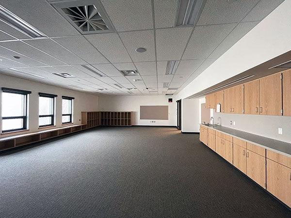 a large empty room with cabinets